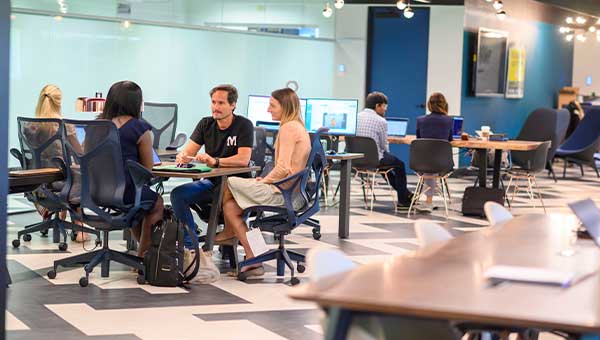 People collaborating at FPL’s 35 Mules, the first in-house innovation hub backed by a global energy leader.
