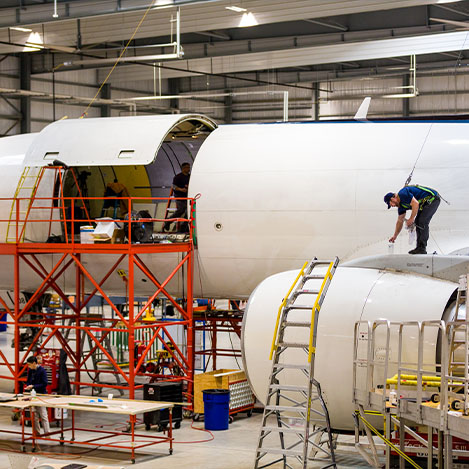 Aviation employees in Florida’s workforce construct an airplane’s outer shell